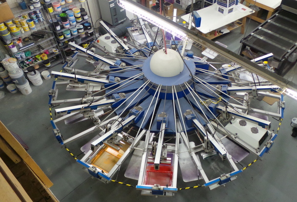 This merry-go-round machine at the Tees for the People facility can screen print up to 700 t-shirts per hour, with up to 10 colours.