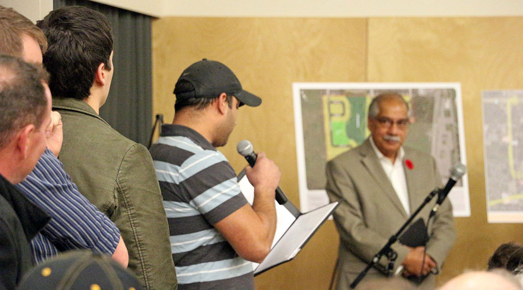 Omar Sultan from the Jackson Trails Community Association, asks a question at the public meeting while councillor Shad Quadri listens in the background. Photo by Shannon Lough.