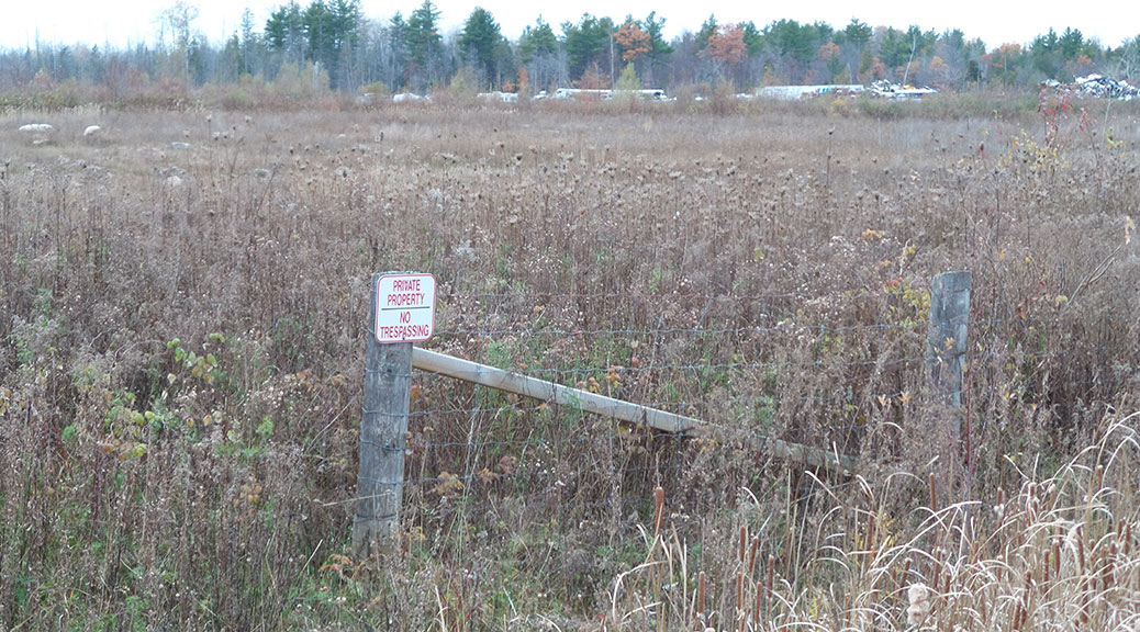 Private property sign at the eastern edge of the Mion property, October 2015. A neighbouring wrecking yard is visible to the west. 