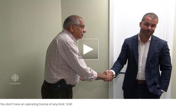 In this screen capture from a CBC story, Councillor Shad Qadri shakes the hand of Magna Terra owner Franco Vigile at an open house at the facility in August. "You don't have an operating license of any kind," Qadri told Vigile.