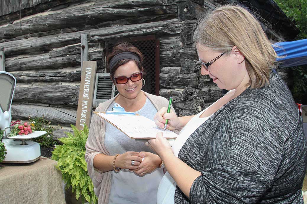 STITTSVILLE, ON, August 14, 2016. Stittsville Assocation President Tanya Hein signs the petition help organize a farmers market at the barn in the Village Square. Barry Gray (StittsvilleCentral)