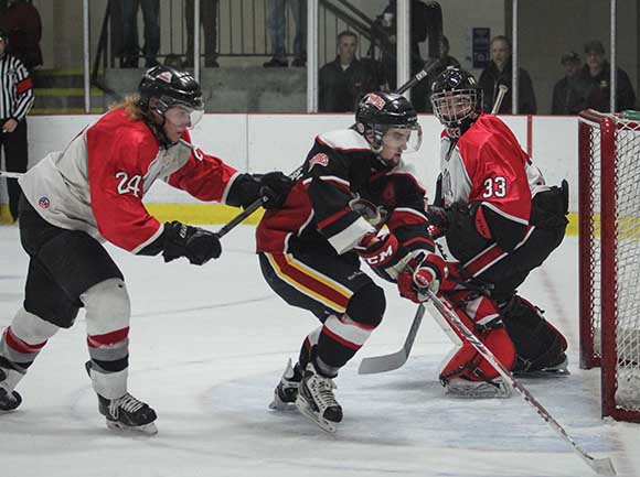 Stittsville defenseman Jake Oliver pushed Casselman Vikings player away from the goal as goalie Matt Couvrette looks on.  Photo by Barry Gray.  Photo by Barry Gray.