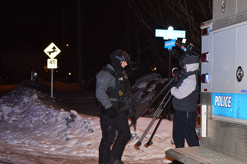 A CTV cameraman on scene with a member of the police tactical squad. Photo by Devyn Barrie.