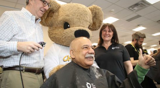 Congrats to Helene Hutchings for organizing another successful Hair Donation Ottawa event today to support cancer research. With donations still coming in, the event will raise at least $90,000. Hutchings is pictured above with the CHEO Bear, watching as Ottawa Mayor Jim Watson shaves Stittsville councillor Shad Qadri's head. Photo by Barry Gray.
