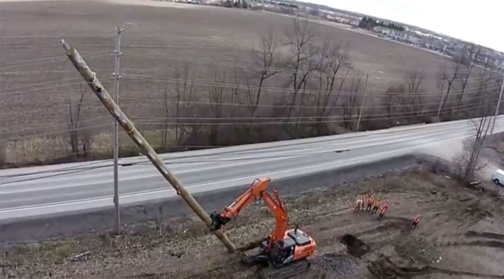Still from Hien Hoang's video showing how hydro poles are erected along Huntmar