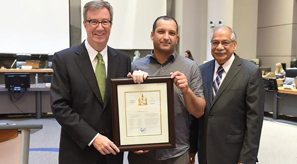 Omar Sultan receives the Mayor's City Builder Award from Mayor Jim Watson and Councillor Shad Qadri