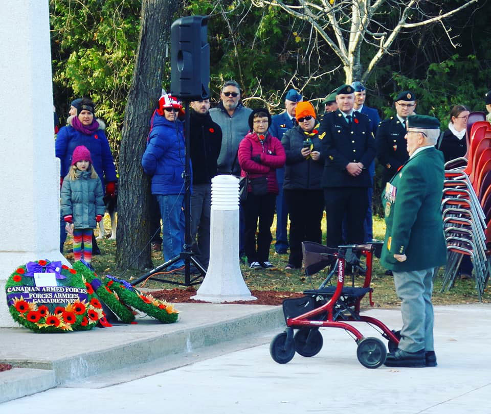 Johnny Leroux, a Korean War veteran, places a wreath at the cenotaph. The Remembrance Day ceremony is held in front of the hockey arena named after Leroux. Photo by G. Gower.