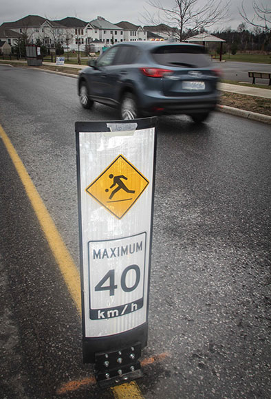 Traffic calming signage along West Ridge. Photo by Barry Gray.