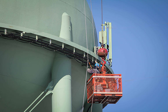 Contractors work on TELUS cell equipment on top of the Stittsville water tower. Photo by Barry Gray.